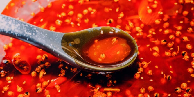 A close up showing a spoonful of chili oil