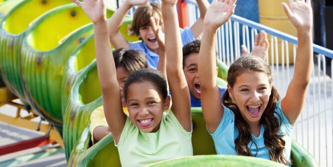 excited kids riding roller coasters