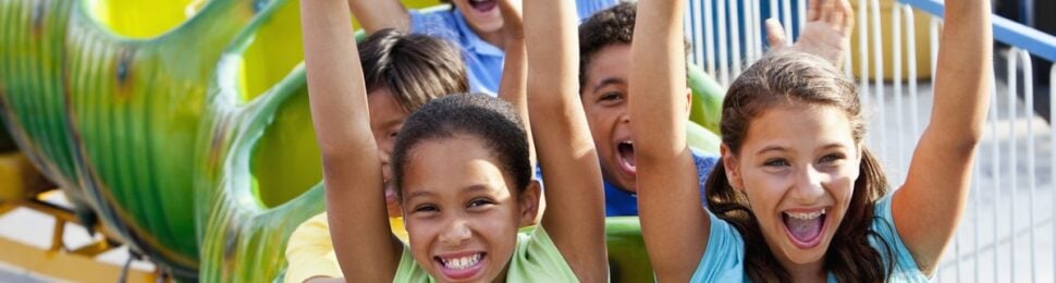 excited kids riding roller coasters
