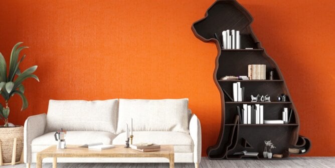 Dopamine decor - Room with orange walls, white couch, and dog-shaped bookshelves