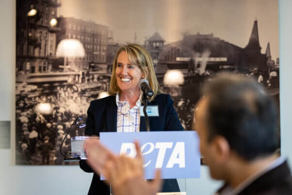 Tracy at a podium