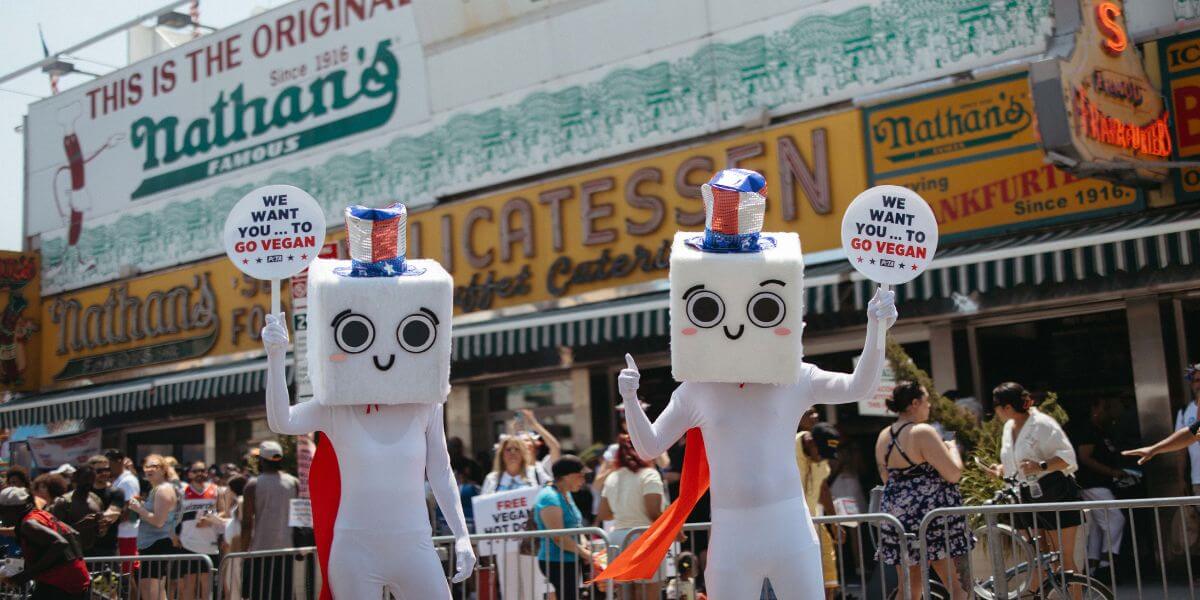 Two tofu mascots in front of Nathan's