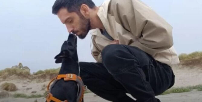 A man and a black dog