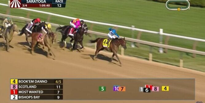 Jockey Paco Lopez whips horse
