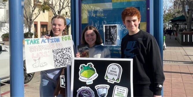 A group of young people with signs