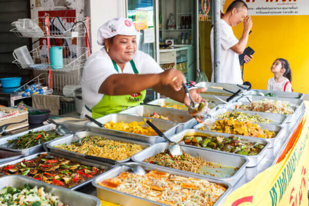 Woman serving food during the vegetarian festival.