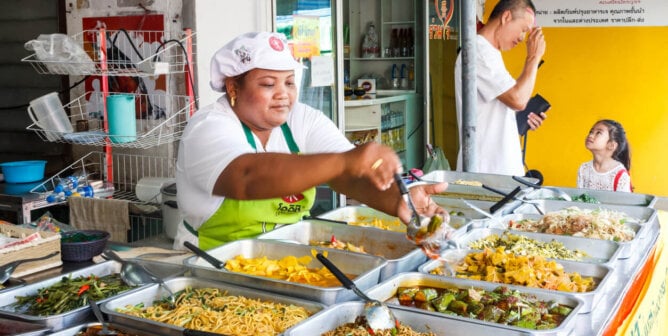 Woman serving food during the vegetarian festival.