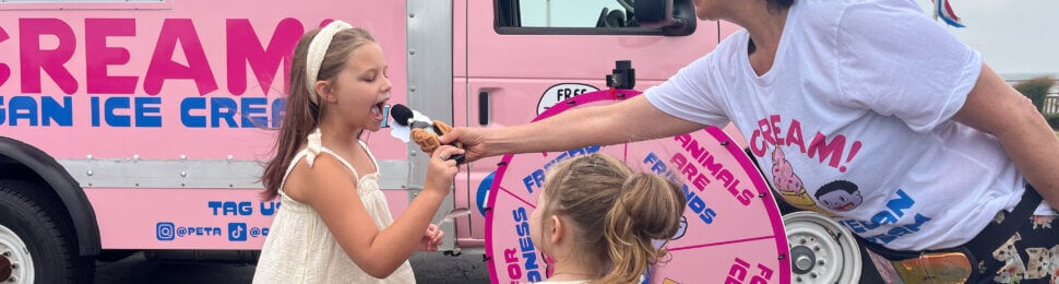 A volunteer giving vegan ice cream to children