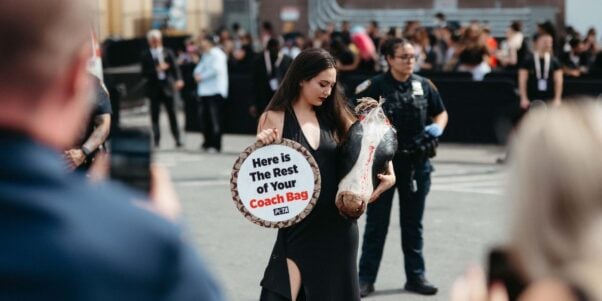 A demonstrator holding a prop cow's head