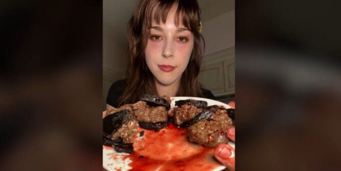 A woman holds a plate of 'oreos'