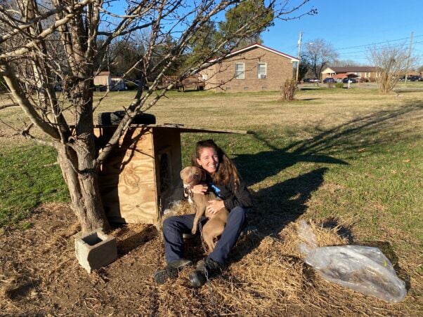 Fieldworker with Mia and a new doghouse