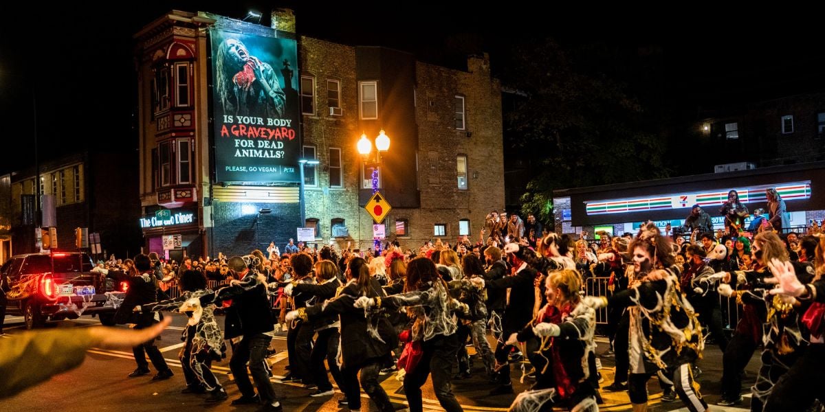 Flash mob of zombies next to a PETA billboard