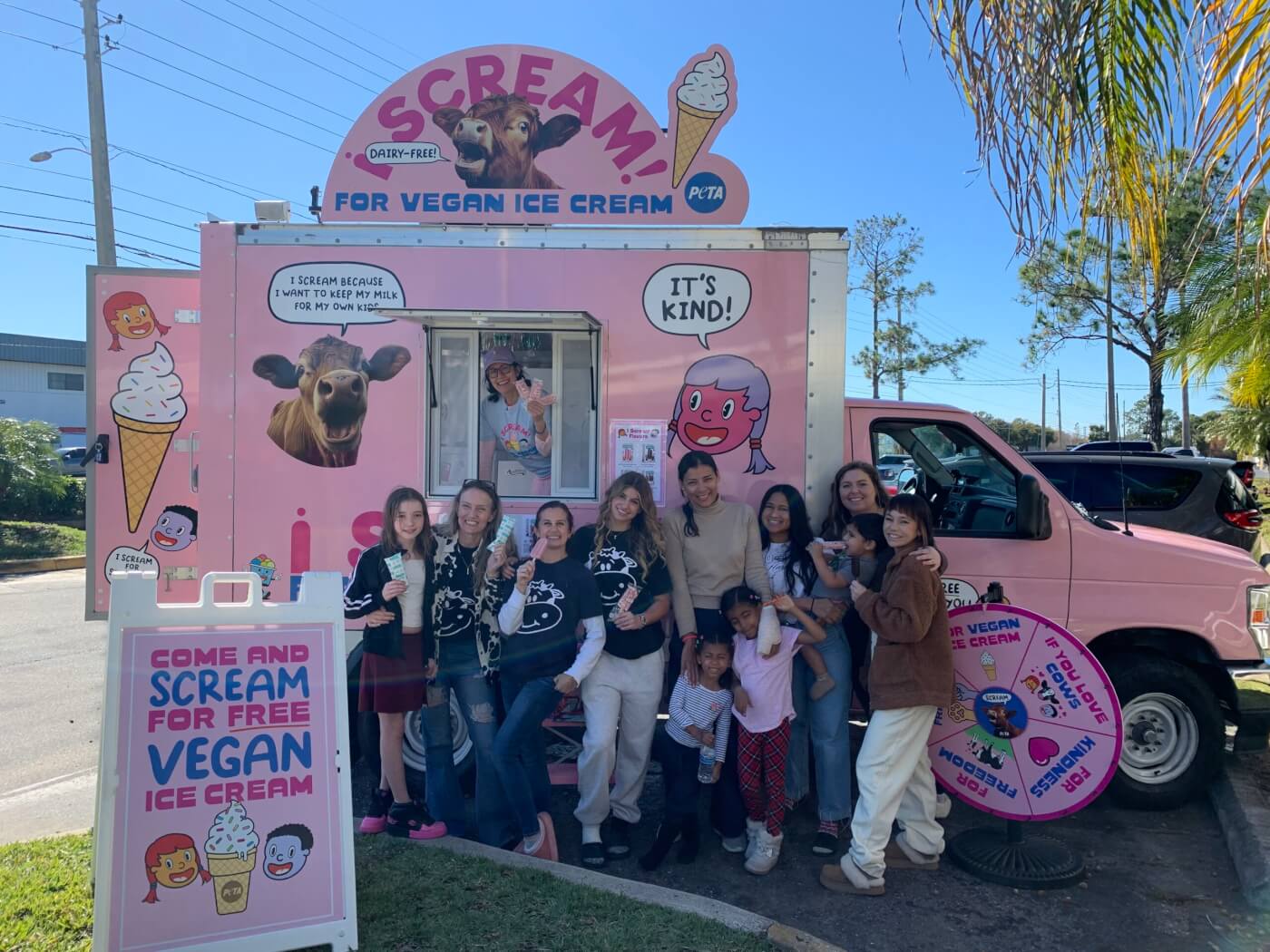 People posing for a group photo in front of the truck
