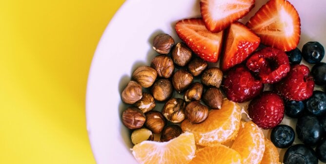FRuit and nuts on white plate