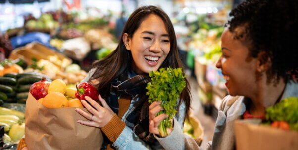 Two women buying fruit and vegetables