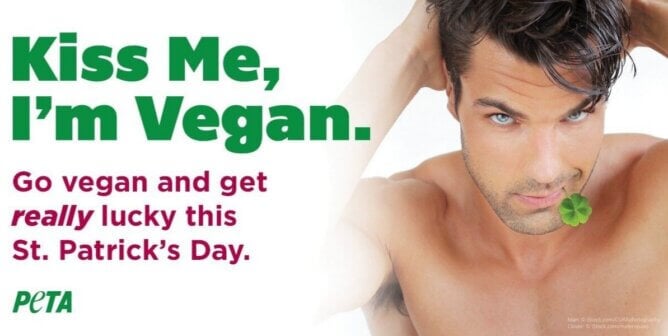Shirtless man with a four leaf clover in his mouth with text to the side reading "Kiss me, I'm vegan. Go vegan and get really lucky this St. Patrick's Day"