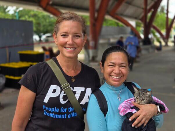 Staff with client who is holding a cat