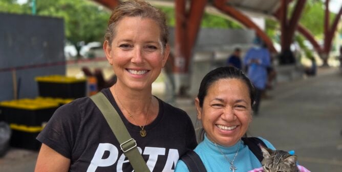 Staff with client who is holding a cat