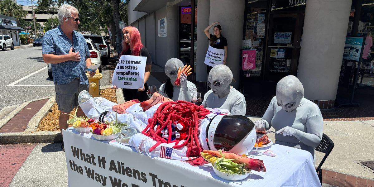 A trio of 'aliens' feast on a prop astronaut