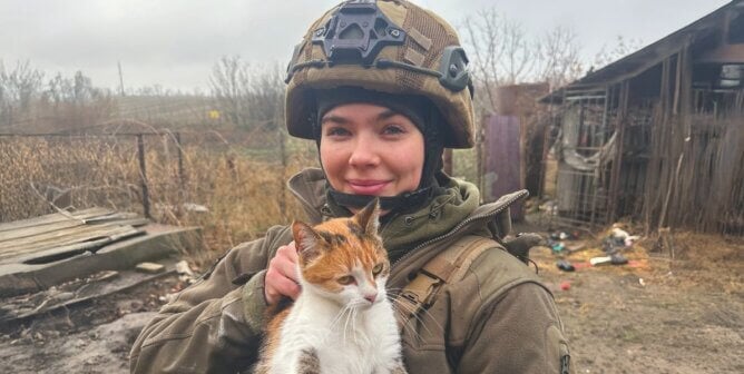 Rescuer holding cat