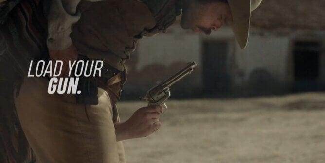 cowboy blowing on a gun in a showdown