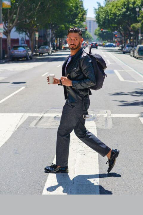 Guy crossing the street in vegan leather