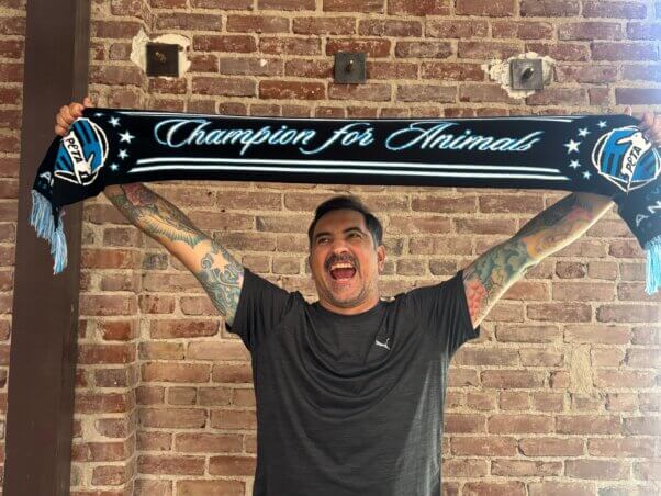 Staffer holding a Champion for animals scarf