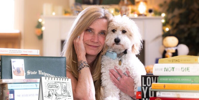a woman and a dog with books