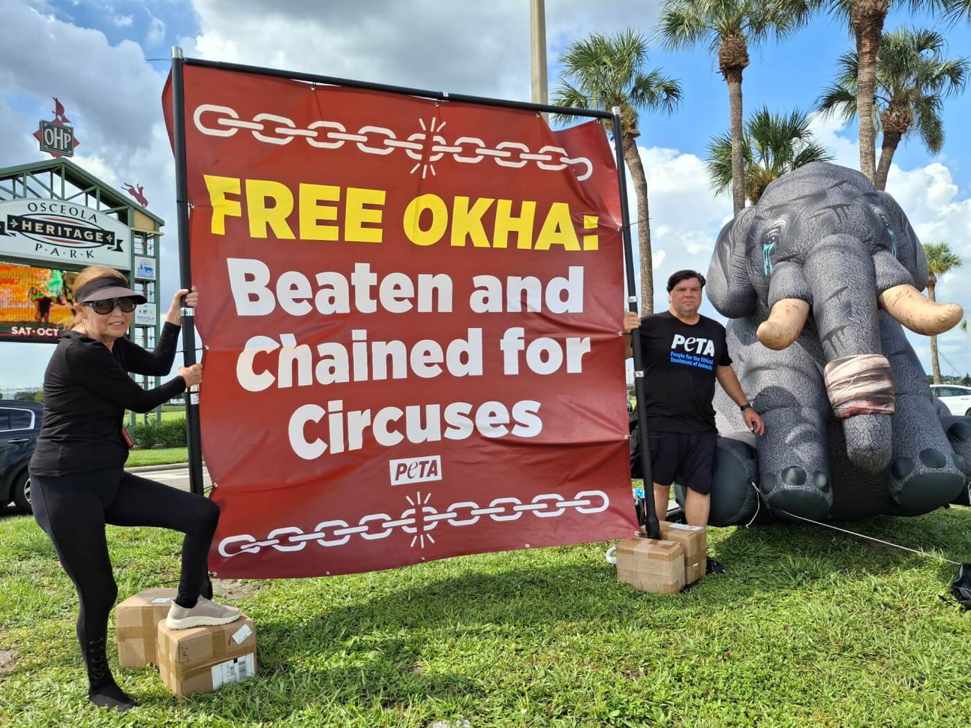 Activists holding up a banner for Okha
