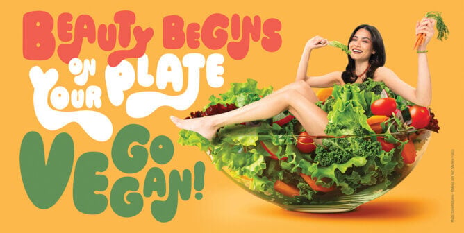 2020 Miss Universe Andrea Meza poses in a giant salad bowl in a PETA Latino ad reading, "Beauty Begins on Your Plate. Go Vegan!"