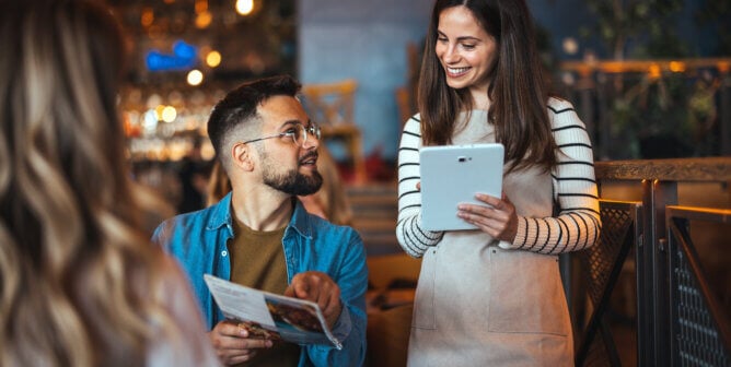 Friendly Bar Interaction Between Diverse Patrons and Waitress