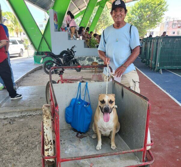 A happy guardian and his dog at PETA's spay/neuter clinic in Cancun.