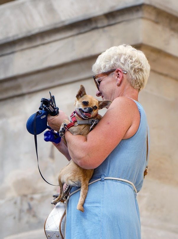 a woman holding a dog